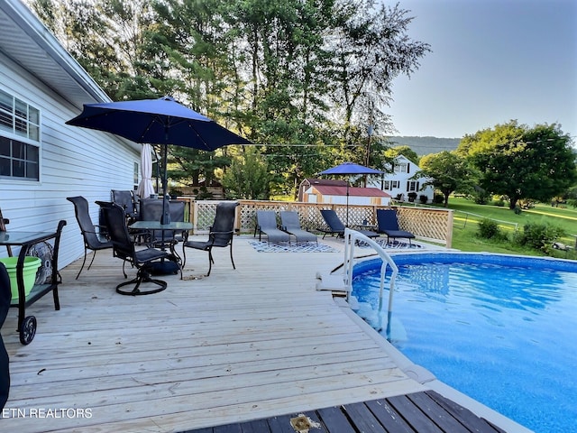 view of swimming pool with a wooden deck