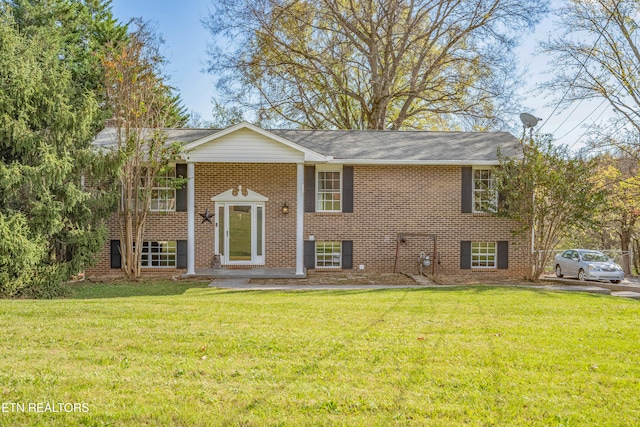 split foyer home with a front lawn