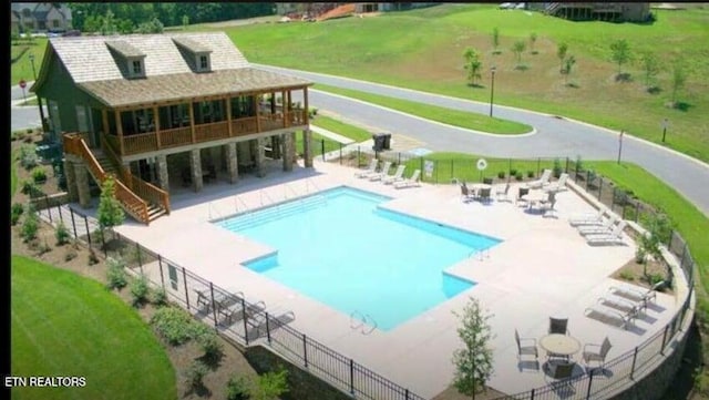 view of pool with a yard and a patio area