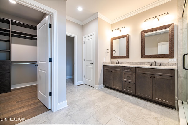 bathroom featuring crown molding, hardwood / wood-style floors, vanity, and a shower with shower door