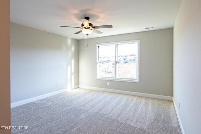 empty room featuring carpet and ceiling fan