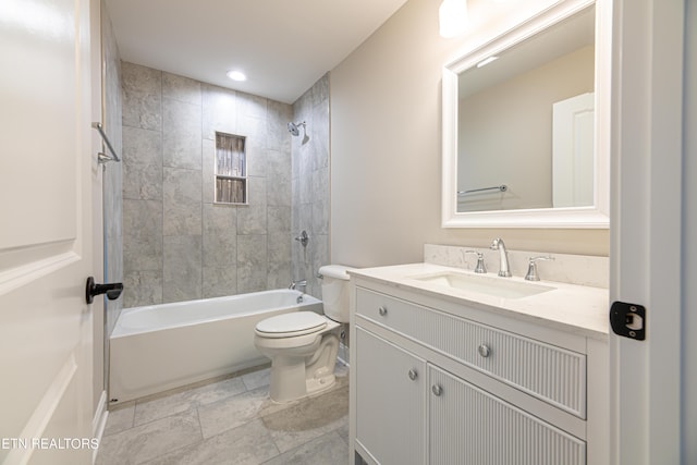 full bathroom with vanity, toilet, and tiled shower / bath