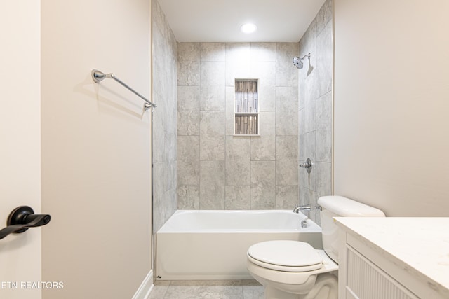 full bathroom with tile patterned flooring, vanity, tiled shower / bath combo, and toilet