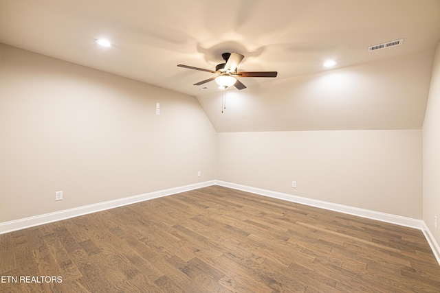 additional living space featuring ceiling fan, lofted ceiling, and dark wood-type flooring