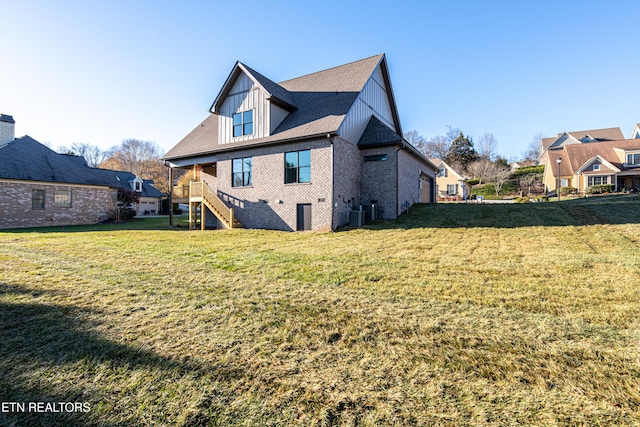 rear view of house featuring a lawn and cooling unit