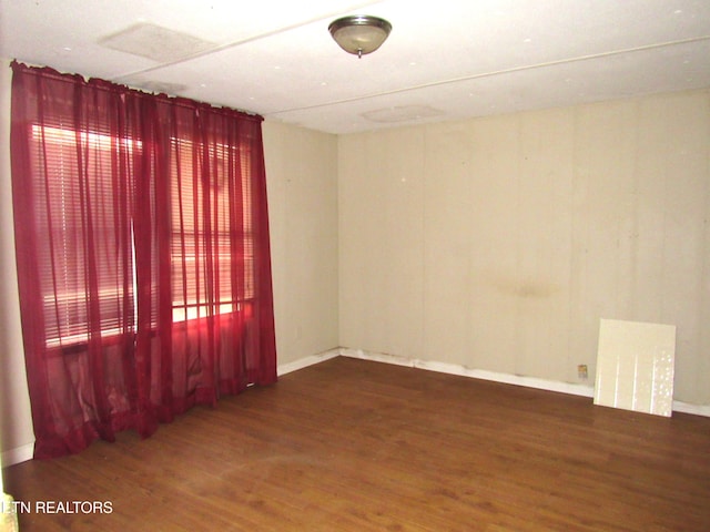 unfurnished room with dark hardwood / wood-style flooring