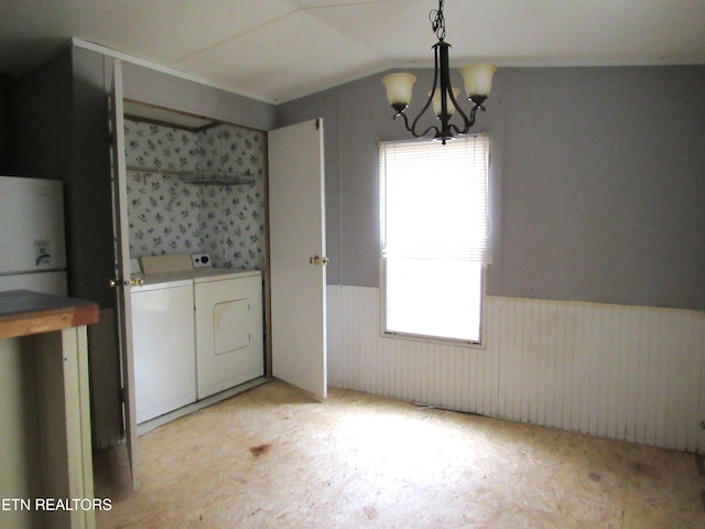 laundry area featuring washing machine and dryer and a chandelier