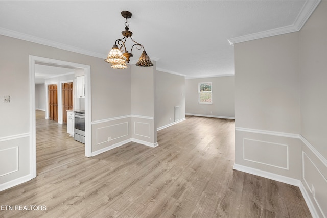 unfurnished dining area with light hardwood / wood-style flooring, a notable chandelier, and crown molding