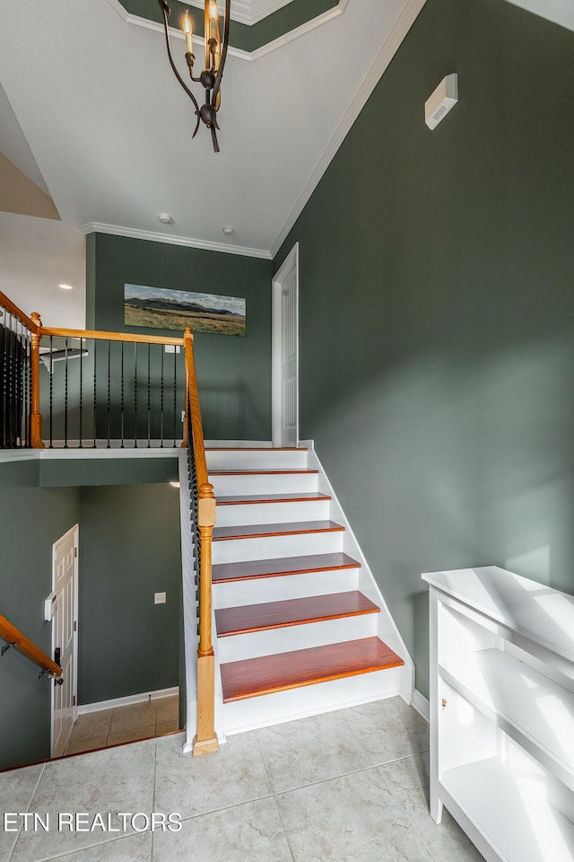 staircase featuring crown molding, tile patterned floors, and a notable chandelier