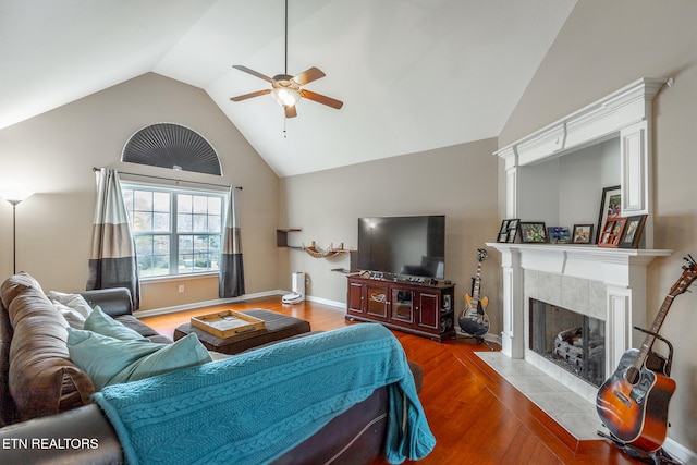 living room featuring ceiling fan, lofted ceiling, a high end fireplace, and dark hardwood / wood-style floors