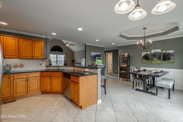 kitchen featuring dishwasher, pendant lighting, kitchen peninsula, a kitchen breakfast bar, and ceiling fan with notable chandelier