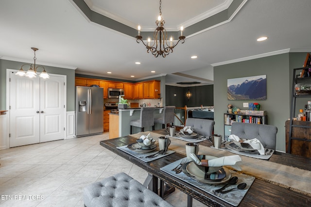 tiled dining area with crown molding, a raised ceiling, and a notable chandelier