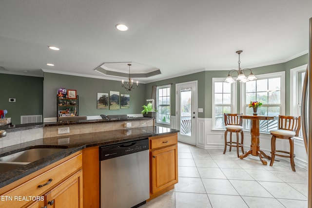 kitchen with dishwasher, pendant lighting, a wealth of natural light, ornamental molding, and a chandelier