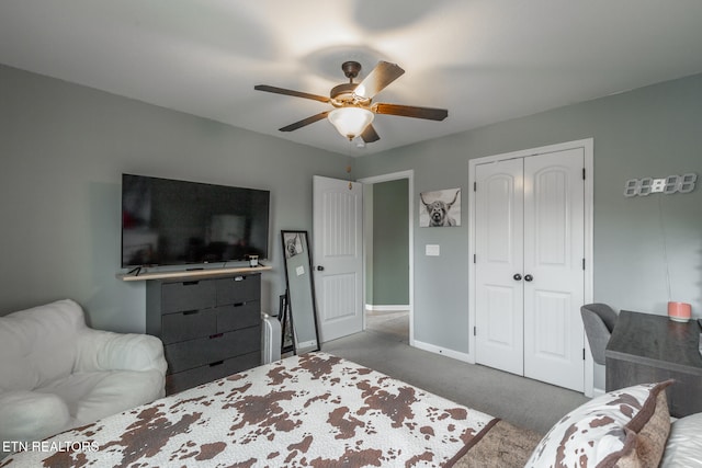 carpeted bedroom with ceiling fan and a closet