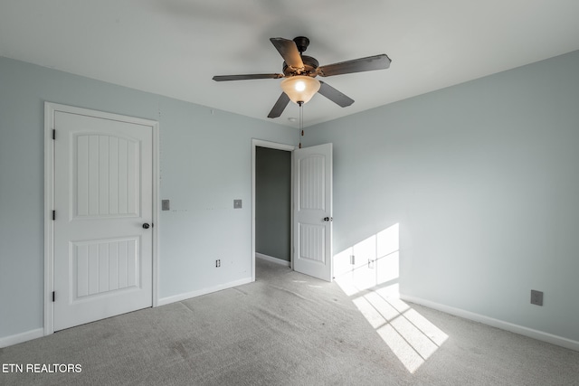 unfurnished bedroom featuring ceiling fan and light colored carpet