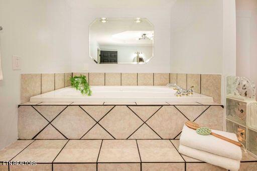 bathroom featuring tiled bath