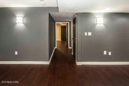 hallway with dark hardwood / wood-style floors