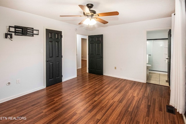 unfurnished bedroom with ceiling fan, dark hardwood / wood-style flooring, and ensuite bathroom