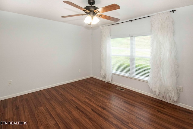 spare room with ceiling fan and dark hardwood / wood-style flooring