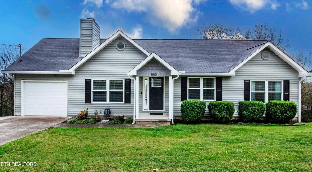 view of front of property with a front lawn and a garage