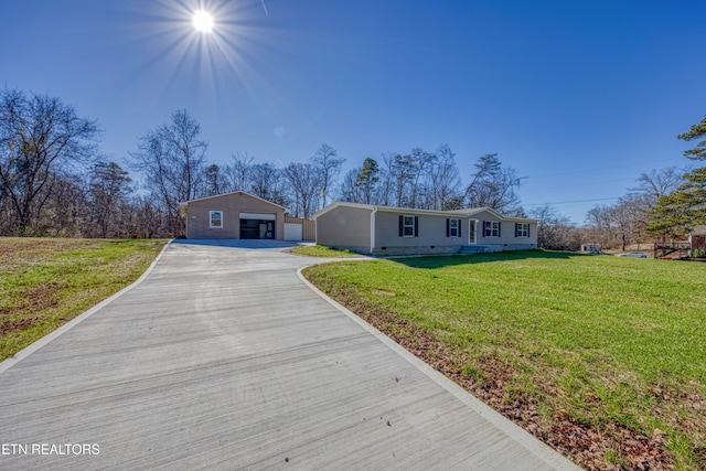 ranch-style house with an outbuilding, a front yard, and a garage