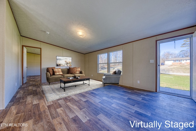 living room with a textured ceiling, crown molding, hardwood / wood-style floors, and vaulted ceiling