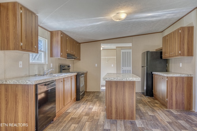 kitchen with black appliances, wood-type flooring, and crown molding