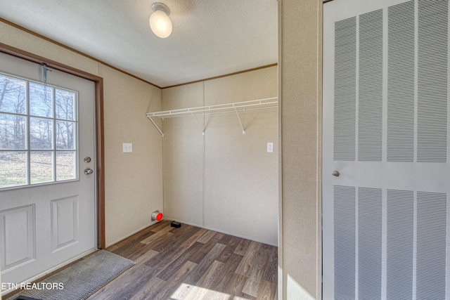 laundry room featuring hardwood / wood-style floors and a textured ceiling