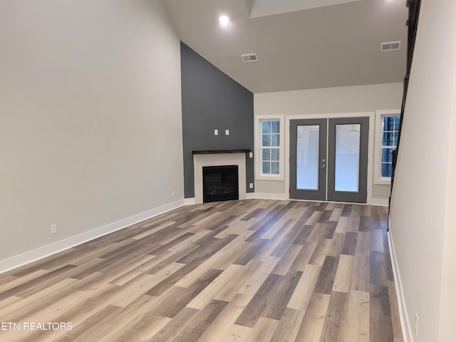 unfurnished living room with french doors and light hardwood / wood-style flooring