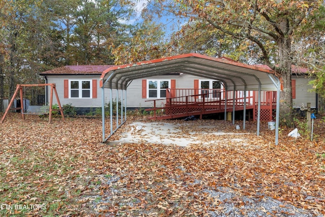 view of front of property with a carport and a deck