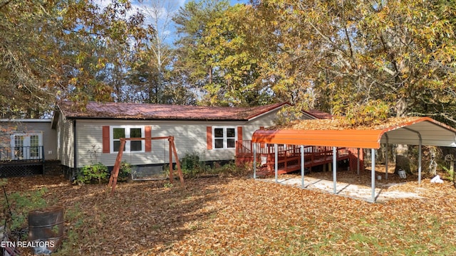 back of house featuring a carport