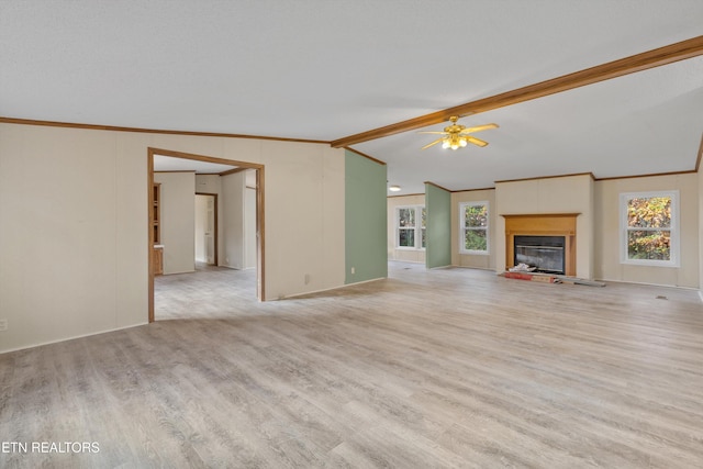 unfurnished living room with ceiling fan, light hardwood / wood-style flooring, crown molding, and vaulted ceiling