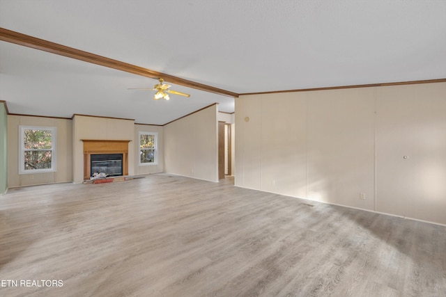 unfurnished living room with ceiling fan, crown molding, light hardwood / wood-style floors, and vaulted ceiling