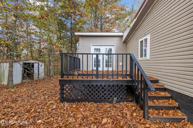 wooden deck with french doors and a storage shed