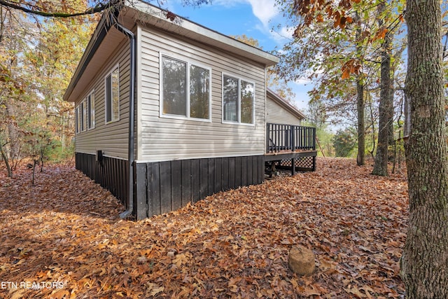 view of side of property with a wooden deck