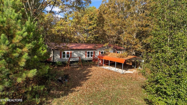 rear view of property with a carport