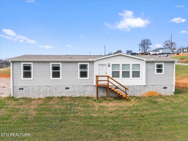 rear view of property with a yard