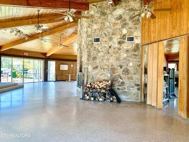 interior space with beam ceiling, wood walls, a towering ceiling, and wooden ceiling