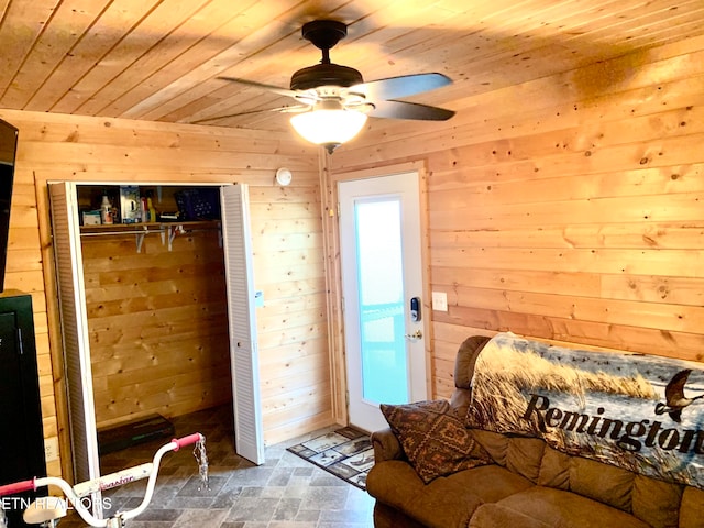 bedroom featuring wooden walls, a closet, and wooden ceiling