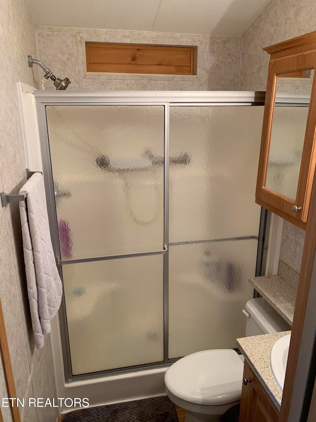 bathroom featuring vanity, toilet, an enclosed shower, and lofted ceiling