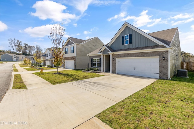 view of front of property featuring central air condition unit, a front yard, and a garage