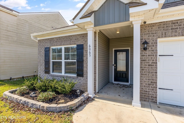 doorway to property with a garage