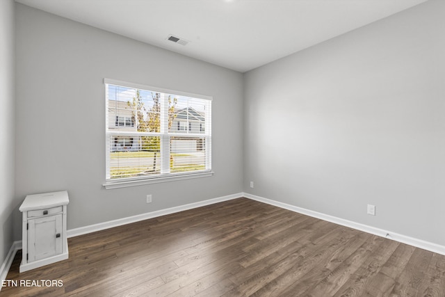 unfurnished room featuring dark hardwood / wood-style floors