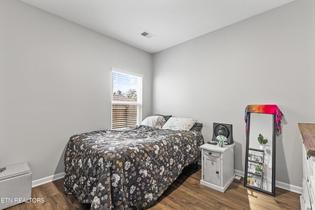 bedroom featuring dark hardwood / wood-style flooring