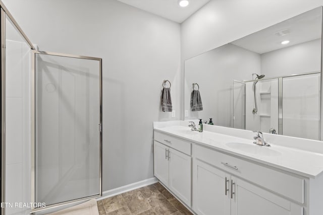 bathroom featuring vanity and an enclosed shower