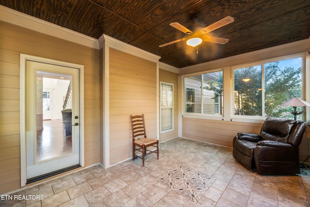 sunroom featuring ceiling fan and wood ceiling