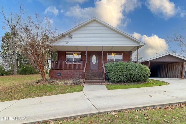 bungalow-style home featuring a carport, covered porch, and a front yard