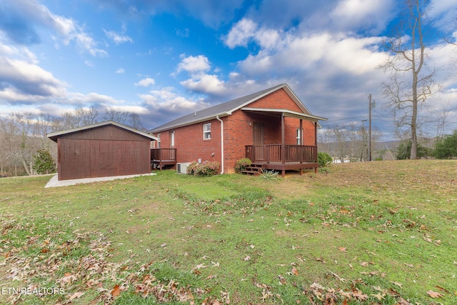 view of side of home featuring a wooden deck, a lawn, and cooling unit