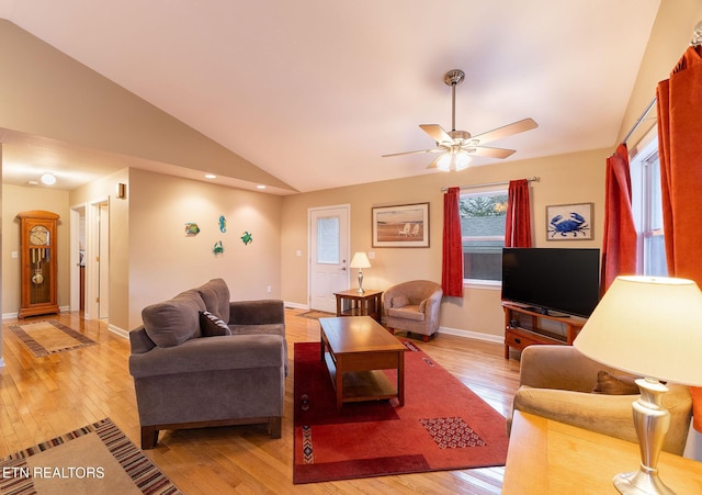 living room with ceiling fan, vaulted ceiling, and light hardwood / wood-style flooring