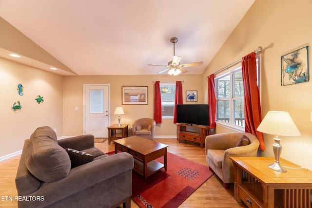 living room with lofted ceiling, light hardwood / wood-style flooring, and ceiling fan